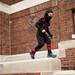 Oskar Roxstrom, seven, runs along a wall dressed as a ninja before the University of Michigan halloween concert on Sunday. Daniel Brenner I AnnArbor.com